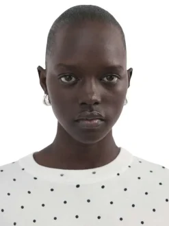 T-shirt blanc à motifs pourvu de manches courtes et d'un col rond
