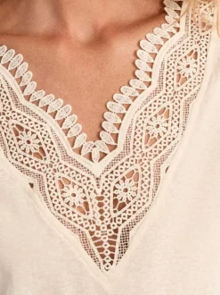 T-shirt écru uni pourvu d'un double décolleté en v avec des détails en dentelle
