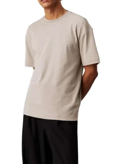T-shirt en coton beige uni avec une coupe oversize et un col rond