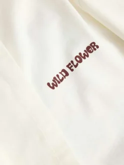 T-shirt en coton blanc à motifs imprimés pourvu d'une coupe droite