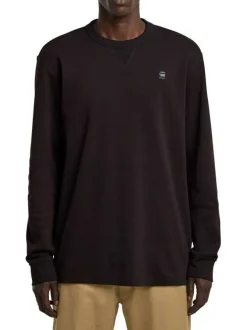 T-shirt en coton noir uni avec logo iconique sur la poitrine et un col rond