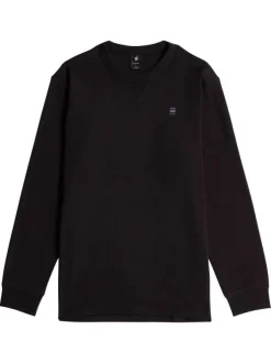 T-shirt en coton noir uni avec logo iconique sur la poitrine et un col rond