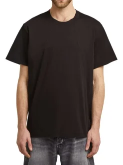 T-shirt en coton noir uni avec un col rond et un patch d'authenticité