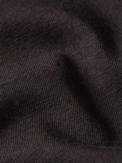 T-shirt en coton noir uni avec un col rond et un patch d'authenticité