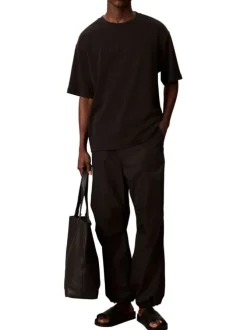 T-shirt en coton noir uni à coupe oversize avec le nom de la marque brodé