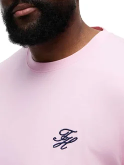 T-shirt en coton rose uni pourvu d'un col rond et de manches courtes