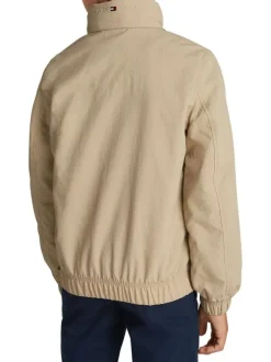 Veste beige uni avec une coupe droite à col montant et fermeture zippée