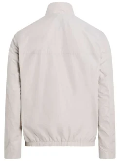 Veste blanche légère avec un aspect satiné un col montant et des poches