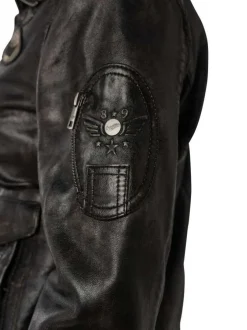 Veste perfecto noire en cuir de mouton avec une coupe bombers et col à rabats